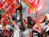 Metalworkers demonstrate as they march with banners and flags in the streets of Paris on October 13, 2017. Several thousand workers have tak...