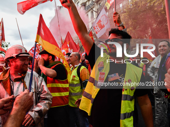 Metalworkers demonstrate as they march with banners and flags in the streets of Paris on October 13, 2017. Several thousand workers have tak...