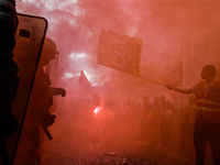 Metalworkers demonstrate as they march with banners and flags in the streets of Paris on October 13, 2017. Several thousand workers have tak...