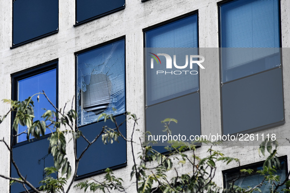 Window of the UIMM building breaks as a fireworks rocket is launched by the Metallurgy workers in Paris on October 13, 2017. Several thousan...