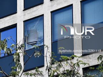 Window of the UIMM building breaks as a fireworks rocket is launched by the Metallurgy workers in Paris on October 13, 2017. Several thousan...