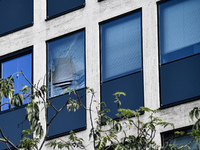 Window of the UIMM building breaks as a fireworks rocket is launched by the Metallurgy workers in Paris on October 13, 2017. Several thousan...