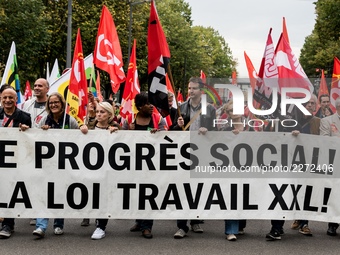 People march behind a banner as thousands gather in the streets of Lyon, France to protest against the labor law at the call of the CGT, the...