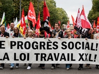 People march behind a banner as thousands gather in the streets of Lyon, France to protest against the labor law at the call of the CGT, the...