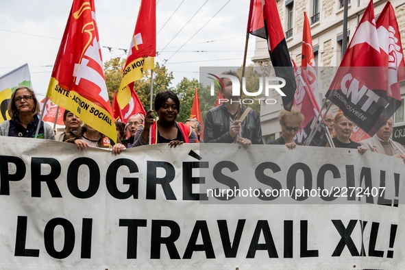 People march behind a banner as thousands gather in the streets of Lyon, France to protest against the labor law at the call of the CGT, the...