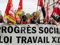 People march behind a banner as thousands gather in the streets of Lyon, France to protest against the labor law at the call of the CGT, the...