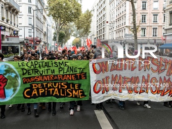 People march behind a banner as thousands gather in the streets of Lyon, France to protest against the labor law at the call of the CGT, the...