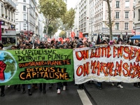 People march behind a banner as thousands gather in the streets of Lyon, France to protest against the labor law at the call of the CGT, the...