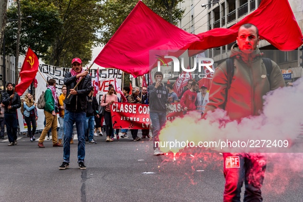 People march behind a banner as thousands gather in the streets of Lyon, France to protest against the labor law at the call of the CGT, the...