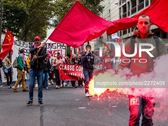 People march behind a banner as thousands gather in the streets of Lyon, France to protest against the labor law at the call of the CGT, the...