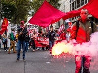 People march behind a banner as thousands gather in the streets of Lyon, France to protest against the labor law at the call of the CGT, the...