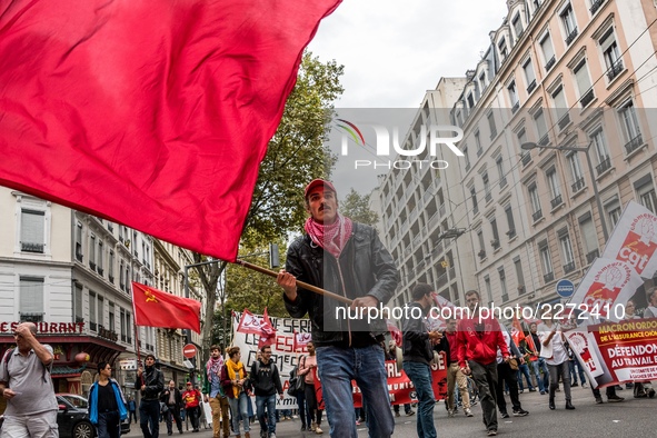 People march behind a banner as thousands gather in the streets of Lyon, France to protest against the labor law at the call of the CGT, the...