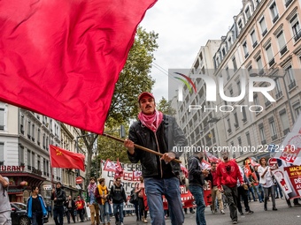 People march behind a banner as thousands gather in the streets of Lyon, France to protest against the labor law at the call of the CGT, the...