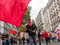 People march behind a banner as thousands gather in the streets of Lyon, France to protest against the labor law at the call of the CGT, the...