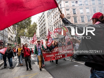 People march behind a banner as thousands gather in the streets of Lyon, France to protest against the labor law at the call of the CGT, the...