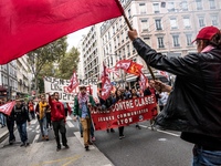 People march behind a banner as thousands gather in the streets of Lyon, France to protest against the labor law at the call of the CGT, the...