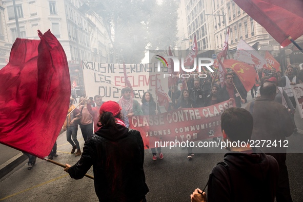 People march behind a banner as thousands gather in the streets of Lyon, France to protest against the labor law at the call of the CGT, the...