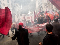 People march behind a banner as thousands gather in the streets of Lyon, France to protest against the labor law at the call of the CGT, the...