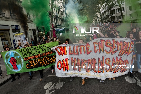 People march behind a banner as thousands gather in the streets of Lyon, France to protest against the labor law at the call of the CGT, the...