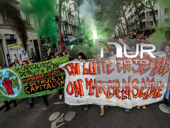 People march behind a banner as thousands gather in the streets of Lyon, France to protest against the labor law at the call of the CGT, the...