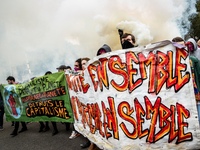 People march behind a banner as thousands gather in the streets of Lyon, France to protest against the labor law at the call of the CGT, the...