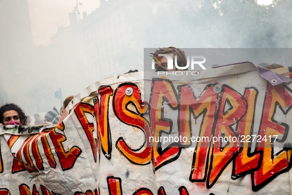 People march behind a banner as thousands gather in the streets of Lyon, France to protest against the labor law at the call of the CGT, the...