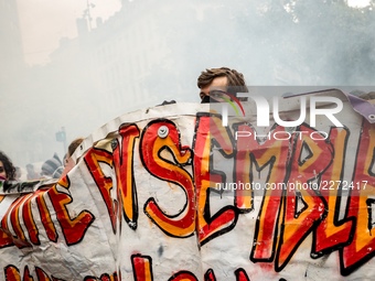 People march behind a banner as thousands gather in the streets of Lyon, France to protest against the labor law at the call of the CGT, the...