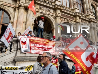 People march behind a banner as thousands gather in the streets of Lyon, France to protest against the labor law at the call of the CGT, the...