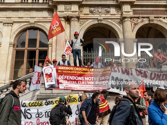 People march behind a banner as thousands gather in the streets of Lyon, France to protest against the labor law at the call of the CGT, the...