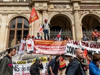 People march behind a banner as thousands gather in the streets of Lyon, France to protest against the labor law at the call of the CGT, the...