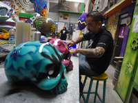 Workers of the 'Taller el Volador' made  the manufacture of skulls and catrinas that will be used for the Day of the Dead Parade inspired by...