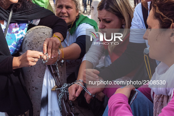 Teachers of the early childhood sector in Roma, protest at the piazza del campidoglio by chained up at the Marc aurel statue  against labour...