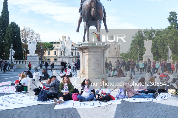 Teachers of the early childhood sector in Roma, protest at the piazza del campidoglio by chained up at the Marc aurel statue  against labour...