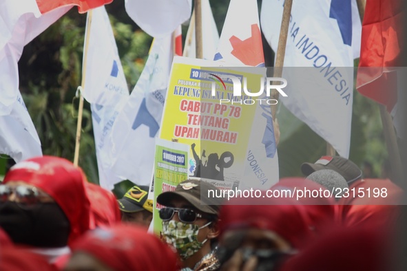 Thousands of workers surrounded the Jakarta Governor's office during a demonstration against the 2018 Regional Minimum Wage (UMP) award at J...