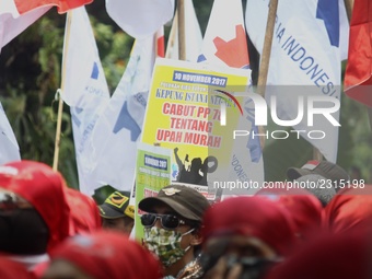 Thousands of workers surrounded the Jakarta Governor's office during a demonstration against the 2018 Regional Minimum Wage (UMP) award at J...