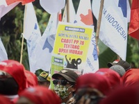 Thousands of workers surrounded the Jakarta Governor's office during a demonstration against the 2018 Regional Minimum Wage (UMP) award at J...