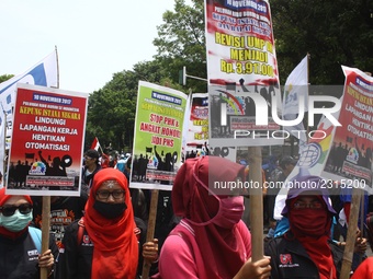 Thousands of workers surrounded the Jakarta Governor's office during a demonstration against the 2018 Regional Minimum Wage (UMP) award at J...