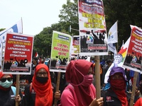 Thousands of workers surrounded the Jakarta Governor's office during a demonstration against the 2018 Regional Minimum Wage (UMP) award at J...