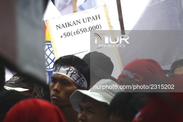 Thousands of workers surrounded the Jakarta Governor's office during a demonstration against the 2018 Regional Minimum Wage (UMP) award at J...