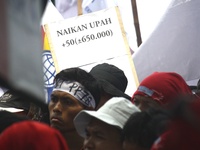 Thousands of workers surrounded the Jakarta Governor's office during a demonstration against the 2018 Regional Minimum Wage (UMP) award at J...