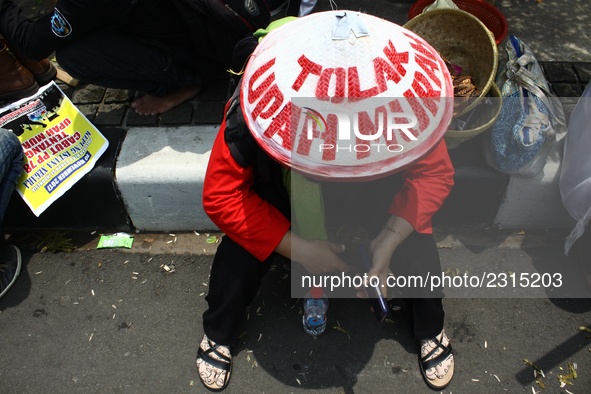 Thousands of workers surrounded the Jakarta Governor's office during a demonstration against the 2018 Regional Minimum Wage (UMP) award at J...