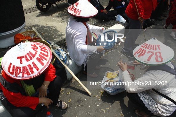 Thousands of workers surrounded the Jakarta Governor's office during a demonstration against the 2018 Regional Minimum Wage (UMP) award at J...