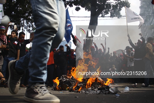 Thousands of workers surrounded the Jakarta Governor's office during a demonstration against the 2018 Regional Minimum Wage (UMP) award at J...