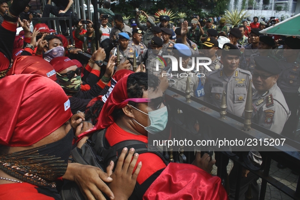 Thousands of workers surrounded the Jakarta Governor's office during a demonstration against the 2018 Regional Minimum Wage (UMP) award at J...