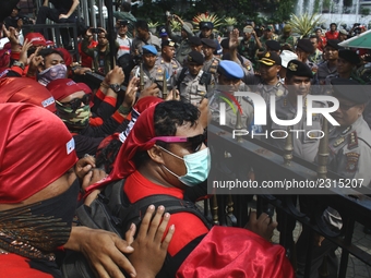 Thousands of workers surrounded the Jakarta Governor's office during a demonstration against the 2018 Regional Minimum Wage (UMP) award at J...