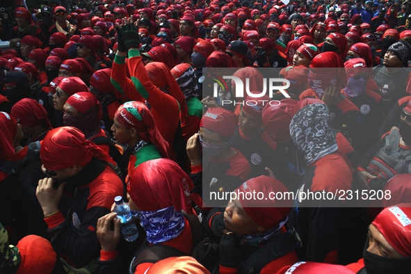 Thousands of workers surrounded the Jakarta Governor's office during a demonstration against the 2018 Regional Minimum Wage (UMP) award at J...