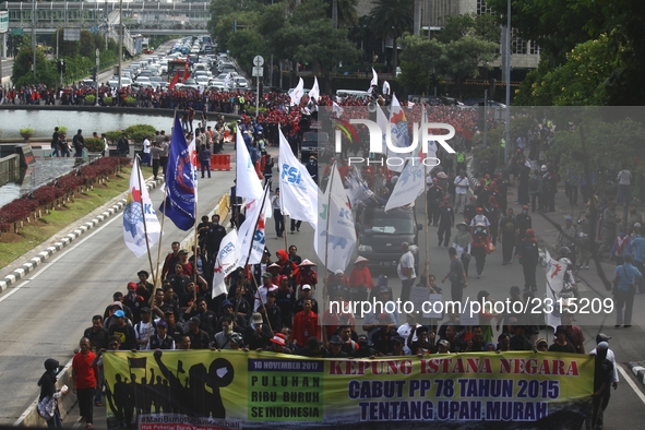 Thousands of workers surrounded the Jakarta Governor's office during a demonstration against the 2018 Regional Minimum Wage (UMP) award at J...