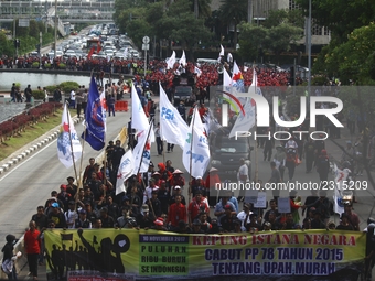 Thousands of workers surrounded the Jakarta Governor's office during a demonstration against the 2018 Regional Minimum Wage (UMP) award at J...