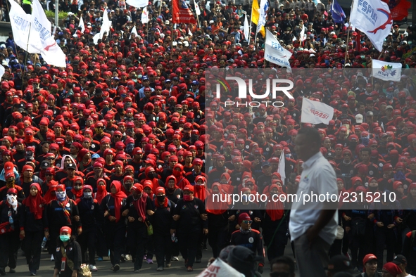 Thousands of workers surrounded the Jakarta Governor's office during a demonstration against the 2018 Regional Minimum Wage (UMP) award at J...