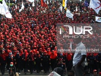 Thousands of workers surrounded the Jakarta Governor's office during a demonstration against the 2018 Regional Minimum Wage (UMP) award at J...